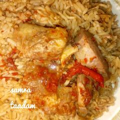 A picture of Jollofrice with meat pepper soup.