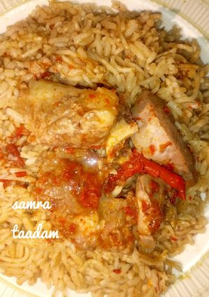 A picture of Jollofrice with meat pepper soup.