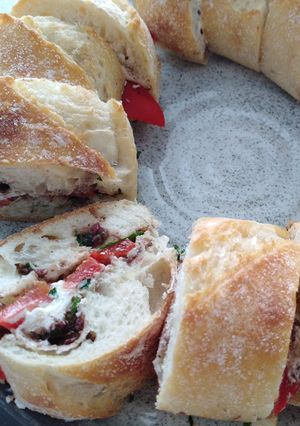 A picture of Goat's cheese, red capsicum and olive tapenade sandwich.
