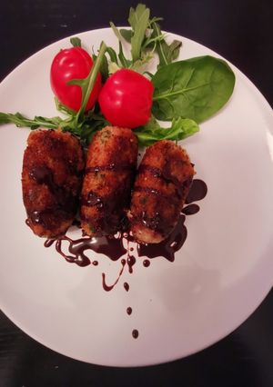 A picture of Duck croquettes w/chocolate spicy dipping sauce.