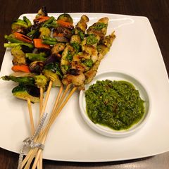 A picture of Homemade kebab with chimichurri sauce.