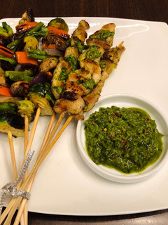 A picture of Homemade kebab with chimichurri sauce.