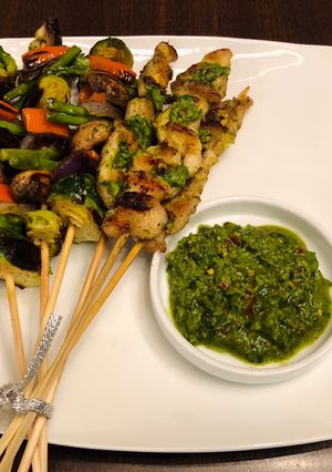 A picture of Homemade kebab with chimichurri sauce.