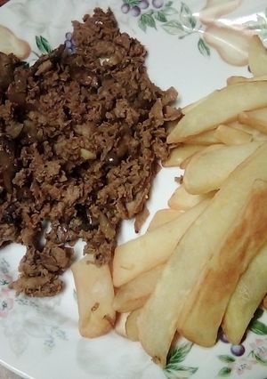A picture of Cheese steak and fries.