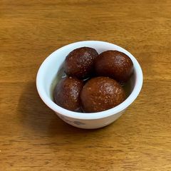 A picture of Gulab jamun with milk powder.