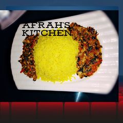 A picture of Yellow Rice with moringa and egg stew.