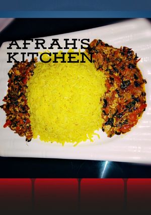 A picture of Yellow Rice with moringa and egg stew.