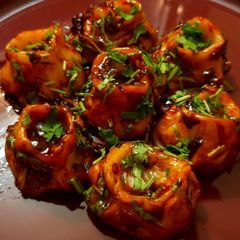 A picture of DEVIL MOMOS | SPICY VEGETABLE MOMO IN Chilli GARLIC SAUCE.
