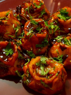 A picture of DEVIL MOMOS | SPICY VEGETABLE MOMO IN Chilli GARLIC SAUCE.