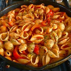 A picture of Conchiglie pasta with tomato sauce.