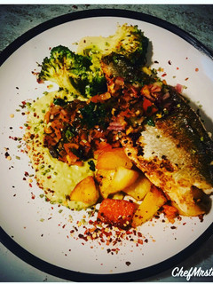 A picture of SeaBass on a Smoked Paprika and Chives Mixed Fried Potatoes with Thyme and Vinegar Garden Peas Purée.