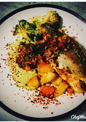 A picture of SeaBass on a Smoked Paprika and Chives Mixed Fried Potatoes with Thyme and Vinegar Garden Peas Purée.
