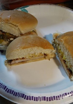 A picture of Pork Sandwich with Pickled Onions.