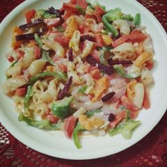 A picture of Pasta salad in white sauce.