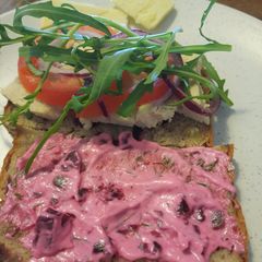 A picture of Poached chicken sandwich with garlic and beet mayo.