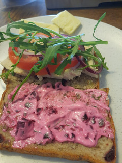 A picture of Poached chicken sandwich with garlic and beet mayo.