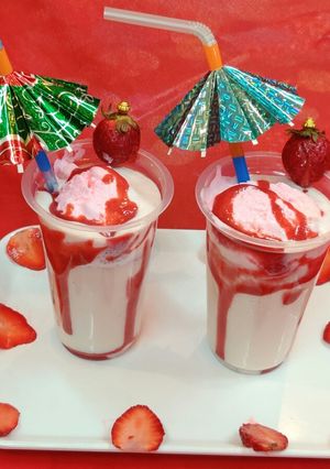 A picture of Strawberry milk shake with dollop of strawberry ice cream.