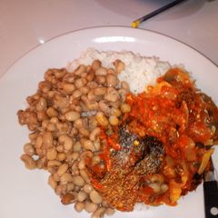 A picture of White rice and beans with fish stew.