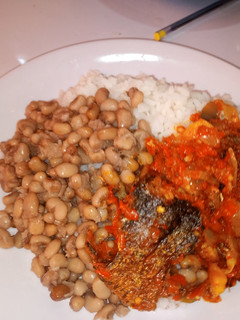 A picture of White rice and beans with fish stew.