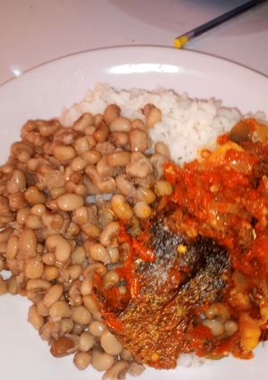 A picture of White rice and beans with fish stew.
