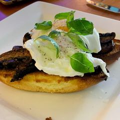 A picture of Portobello mushrooms with brioche and poached egg.