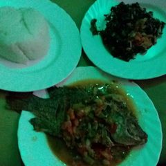A picture of Ugali, wet fried fish with spinach.
