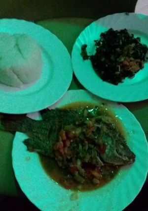 A picture of Ugali, wet fried fish with spinach.