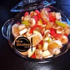 A picture of Fruits salad with mint leaves and lemon grass syrup.