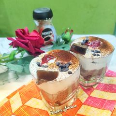 A picture of Coffee chocolate mousse with whipped cream.