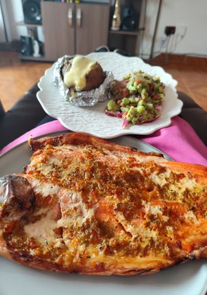 A picture of Barrel-Smoked Trout with Baked Potato and Salad.