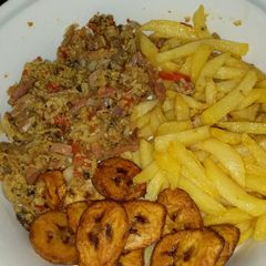A picture of Irish plantain and egg sauce with sausage.