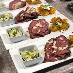 Smoked Rib-eye over Mustard Sauce, Loaded Smashed Potatoes, and Cucumber Salad A picture of Smoked Rib-eye over Mustard Sauce, Loaded Smashed Potatoes, and Cucumber Salad.