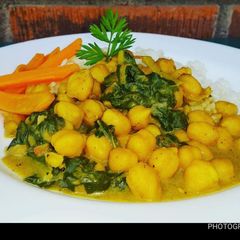 A picture of Chickpeas with spinach,coconut rice and carrots.