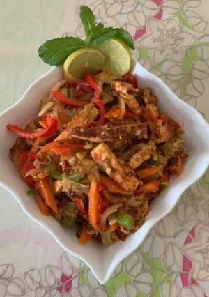 A picture of Grilled paneer salad with veggies and herbs.