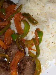 A picture of Meatballs with veggies and steamed rice.