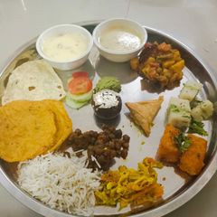 A picture of Lunch plate kheer served with puri.
