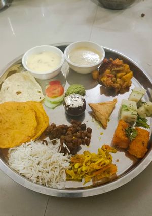 A picture of Lunch plate kheer served with puri.