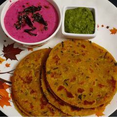 A picture of Poha Paratha with Beetroot Raita.