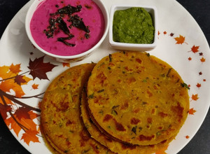 A picture of Poha Paratha with Beetroot Raita.