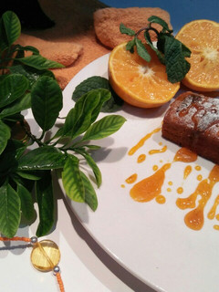 A picture of Orange cake with orange sauce.