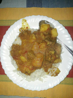 A picture of Rice with beef stew mixed with potatoes.