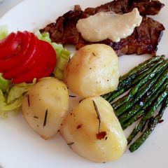 A picture of Sirloin steak with roast potatoes.