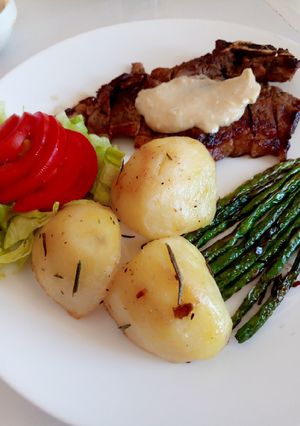 A picture of Sirloin steak with roast potatoes.