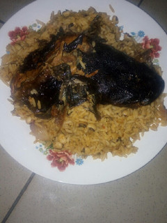 A picture of Jollof rice and beans with dry Fish.
