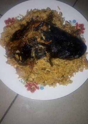 A picture of Jollof rice and beans with dry Fish.
