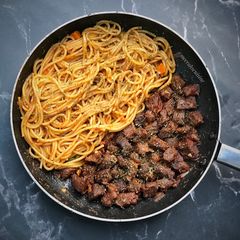 A picture of Pasta and pan stirred beef.