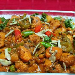 A picture of Spicy Chicken with Capsicum and Green Peas.
