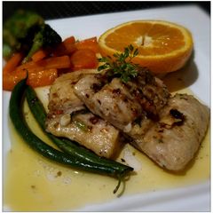 A picture of Grilled Fish with tangy orange- garlic-butter sauce.