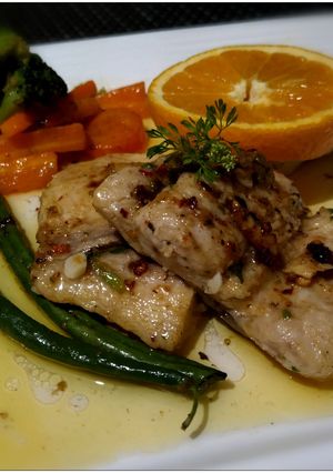A picture of Grilled Fish with tangy orange- garlic-butter sauce.