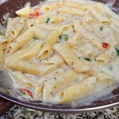 A picture of Penne in white sauce.